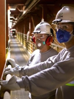two-men-with-hard-hats-and-respirators-standing-inside-loading-facility-in-port-santos_saopaulo-1033 two-men-with-hard-hats-and-respirators-standing-inside-loading-facility-in-port-santos_saopaulo-1033